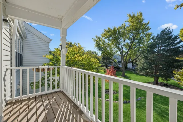 a balcony with wooden floor and fence