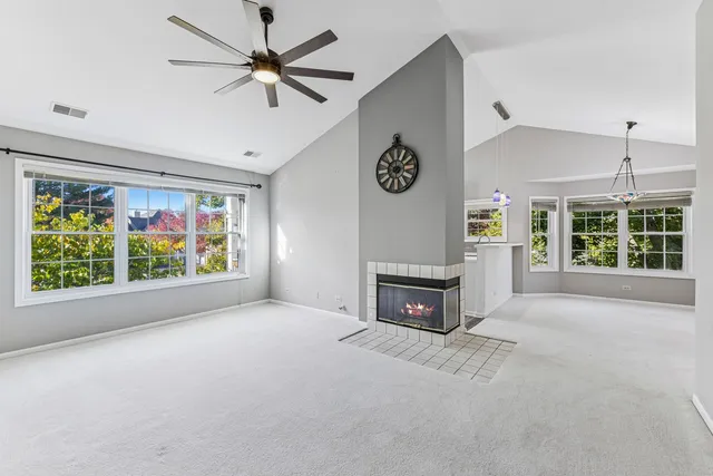 a view of a livingroom with a fireplace and a window