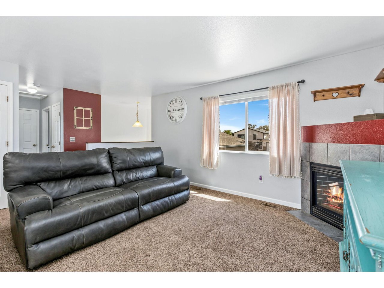 233 East 19th Street Road Greeley, CO 80631 - Photo 3 of 22 a living room with furniture and a fireplace