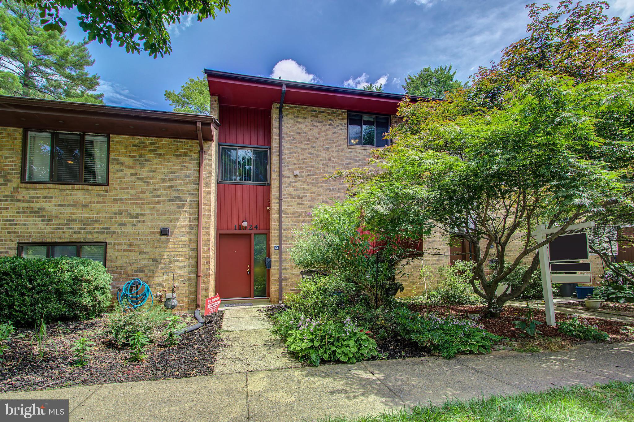 a front view of a house with plants