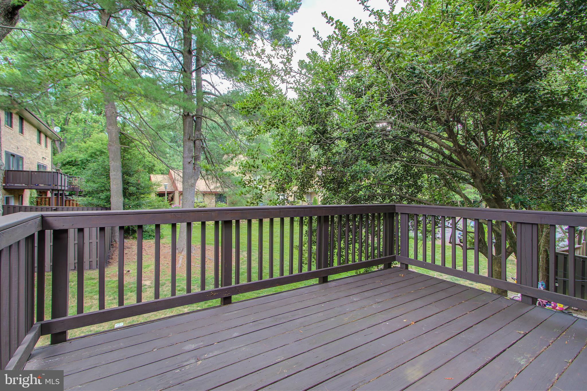 11024 Saffold Way Reston, VA 20190 - Photo 14 of 50 a view of balcony with wooden floor and fence
