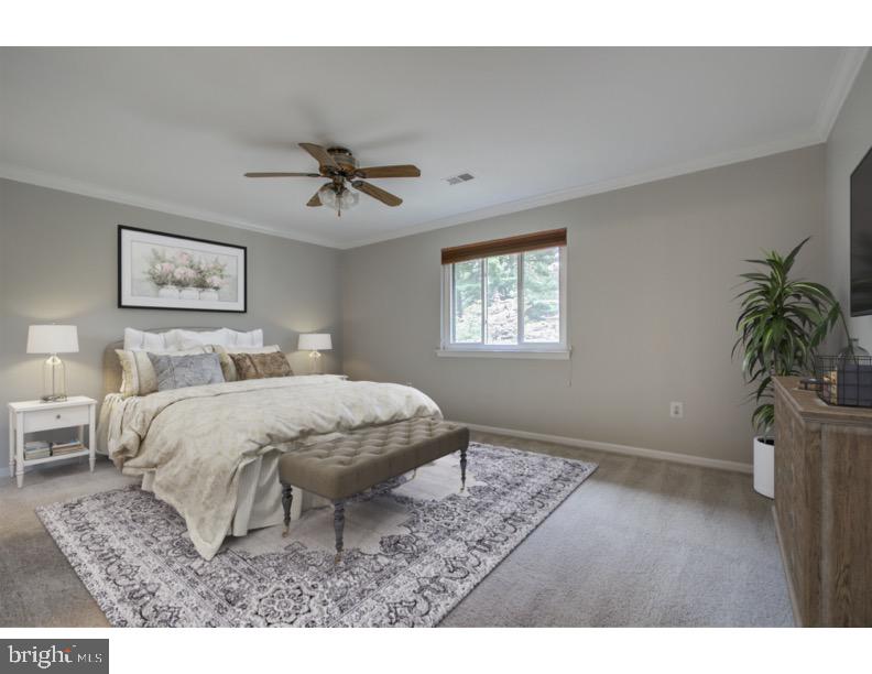 11024 Saffold Way Reston, VA 20190 - Photo 19 of 50 a spacious bedroom with a bed a dresser with wooden floor