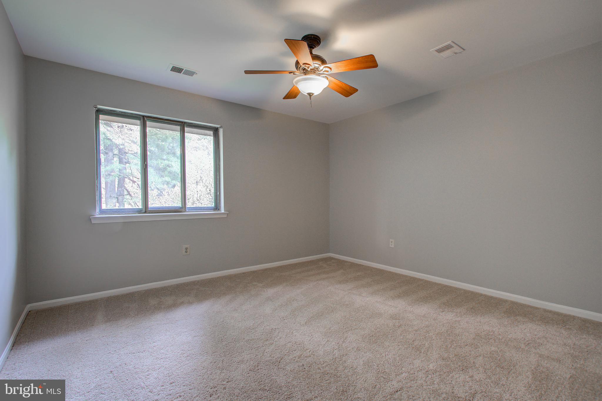 11024 Saffold Way Reston, VA 20190 - Photo 23 of 50 an empty room with ceiling fan and window