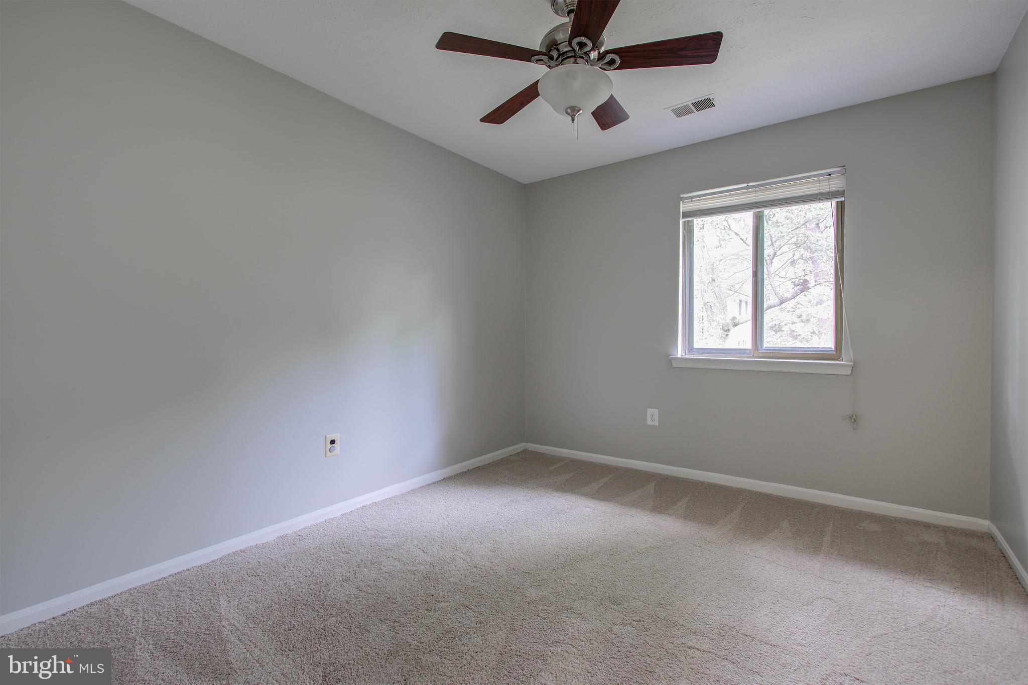 11024 Saffold Way Reston, VA 20190 - Photo 25 of 50 an empty room with a window and a fan