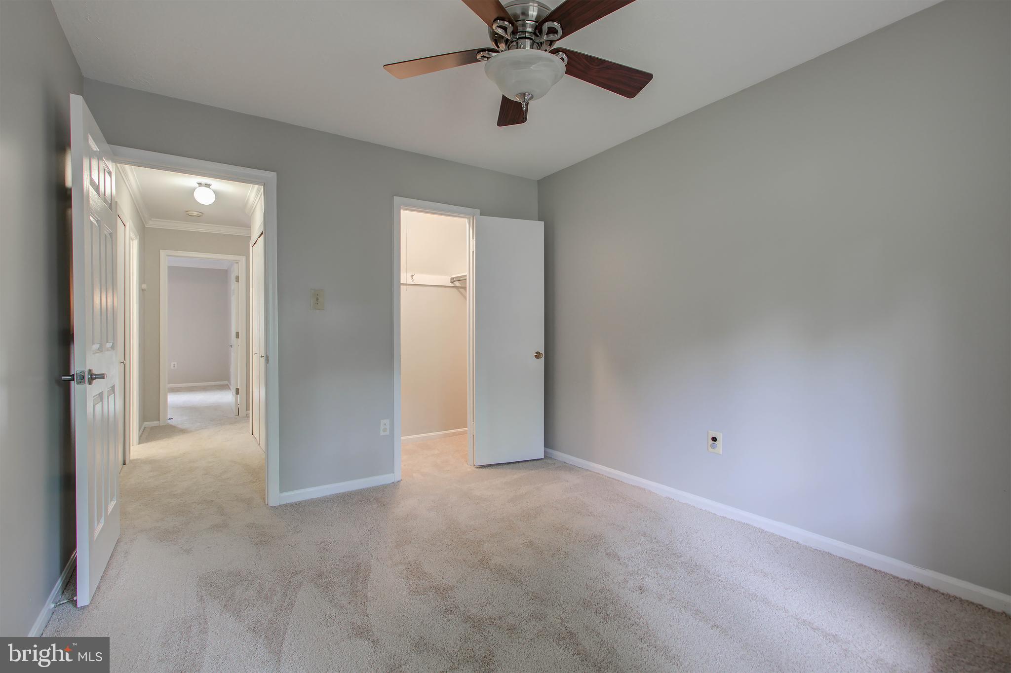 11024 Saffold Way Reston, VA 20190 - Photo 26 of 50 an empty room with chandelier fan and windows