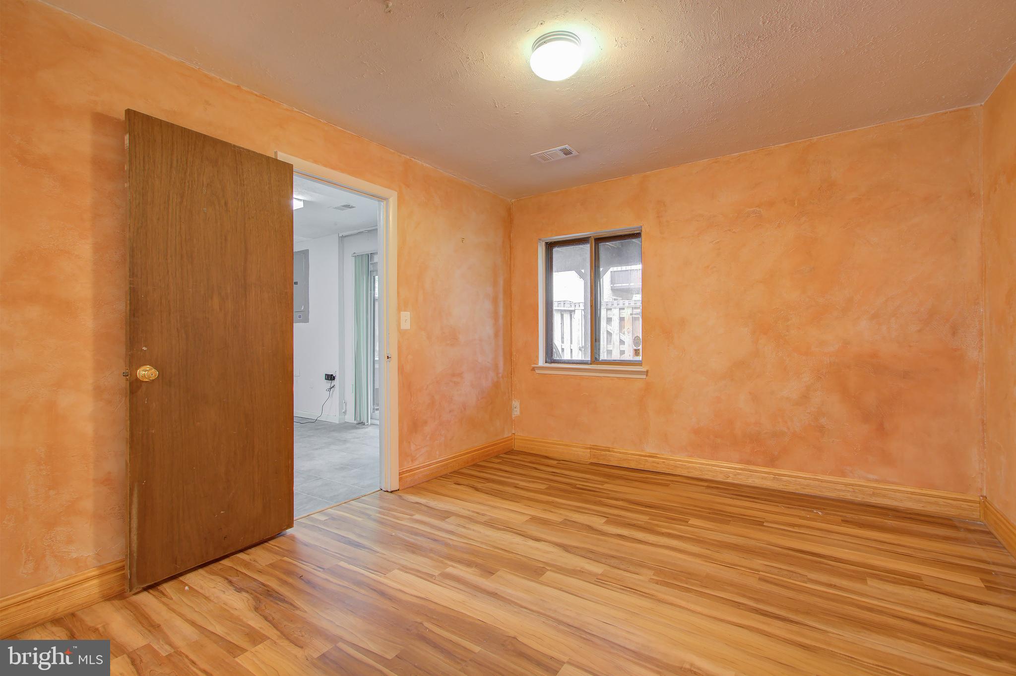11024 Saffold Way Reston, VA 20190 - Photo 34 of 50 a view of an empty room with wooden floor and a window