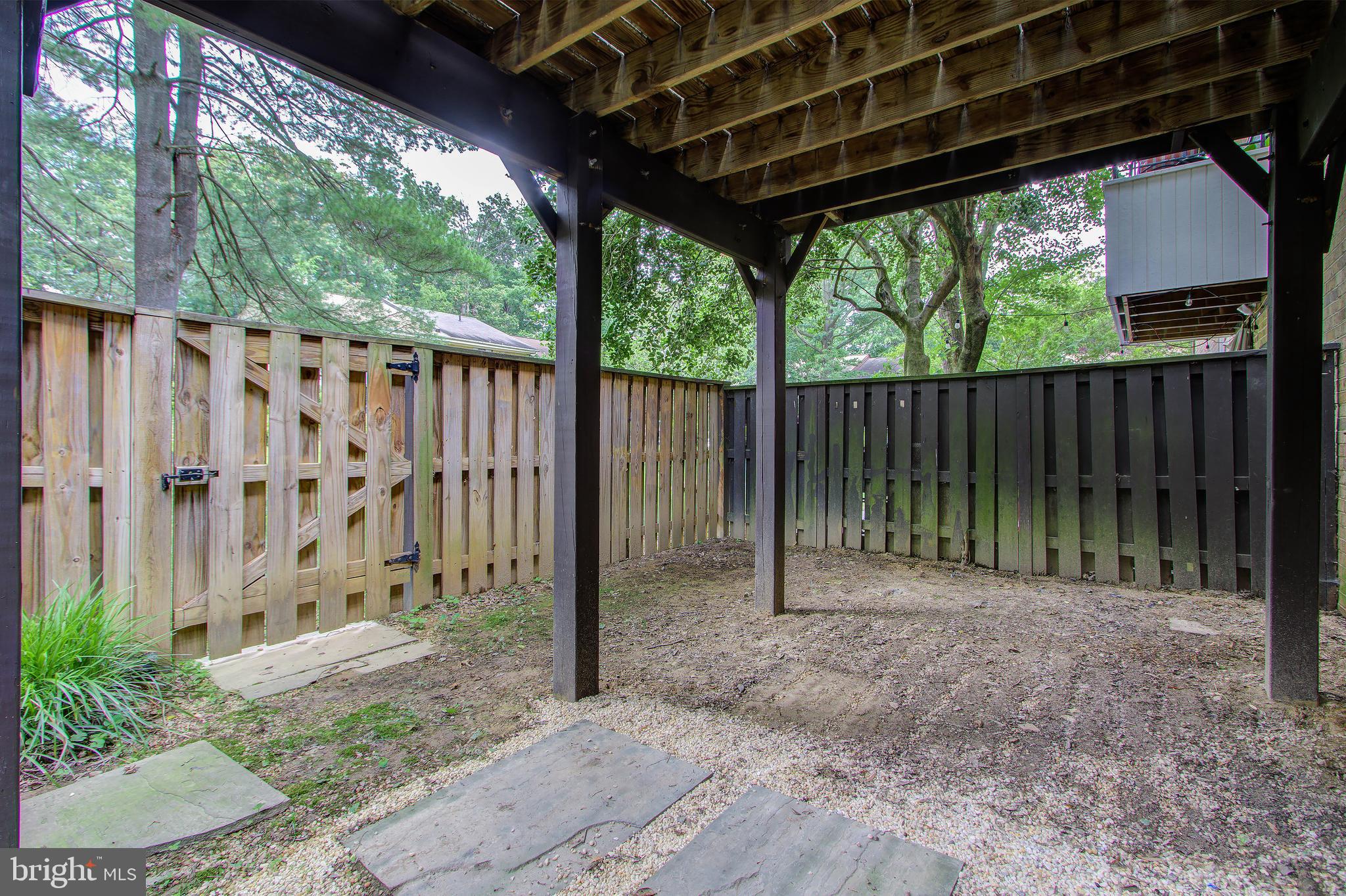 11024 Saffold Way Reston, VA 20190 - Photo 39 of 50 a view of a backyard with plants and wooden fence