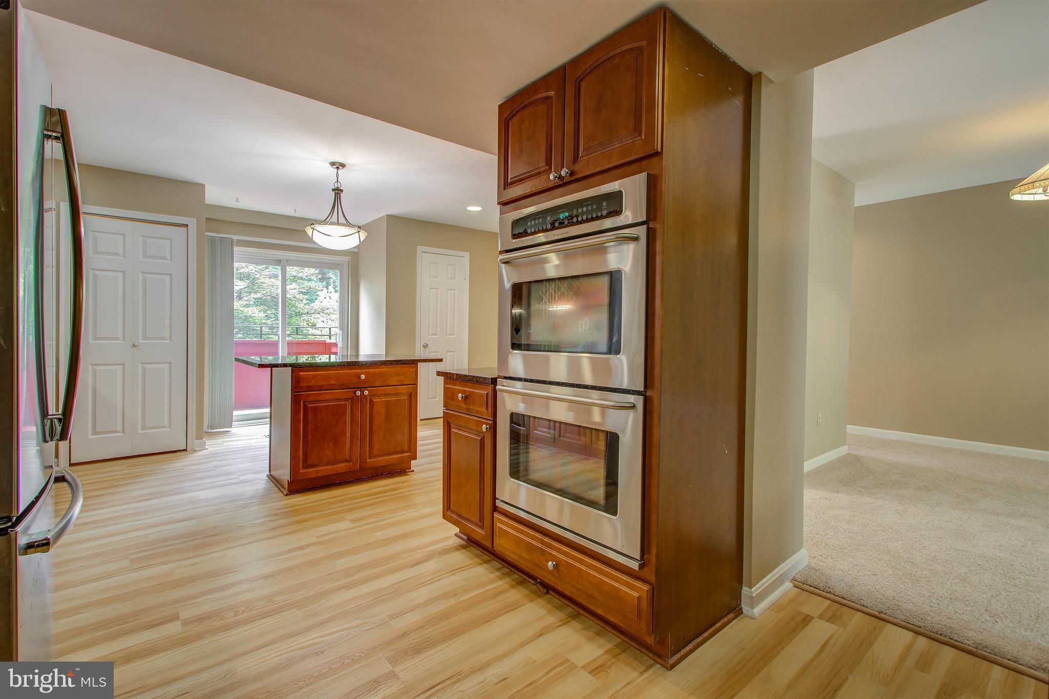 11024 Saffold Way Reston, VA 20190 - Photo 9 of 50 a kitchen with stainless steel appliances granite countertop a refrigerator and a stove