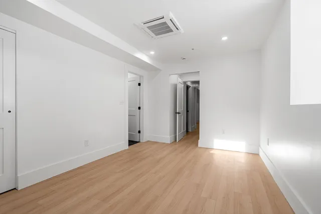 a view of hallway with wooden floor