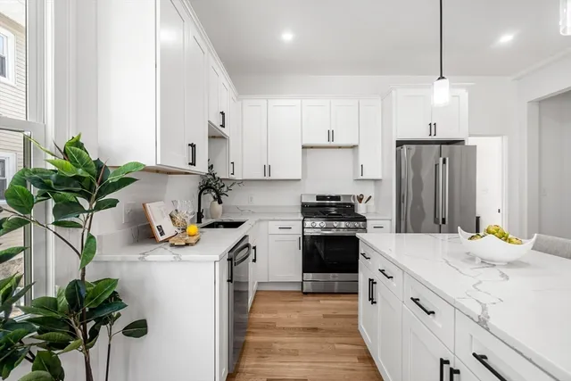 a kitchen with a sink refrigerator and a counter top space