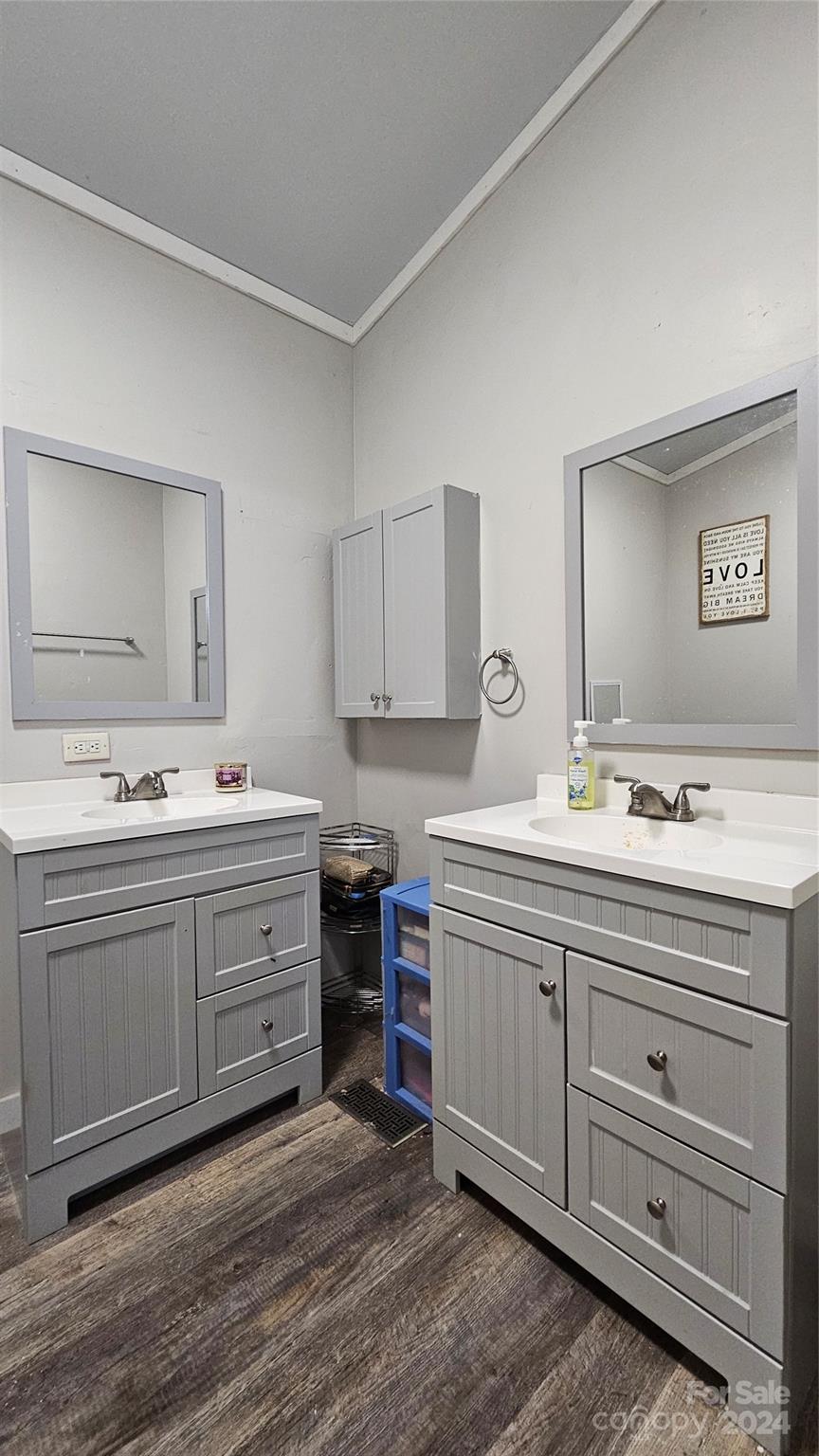 5015 Medlin Road Monroe, NC 28112 - Photo 14 of 19 a view with double vanity sink a mirror and a lamp