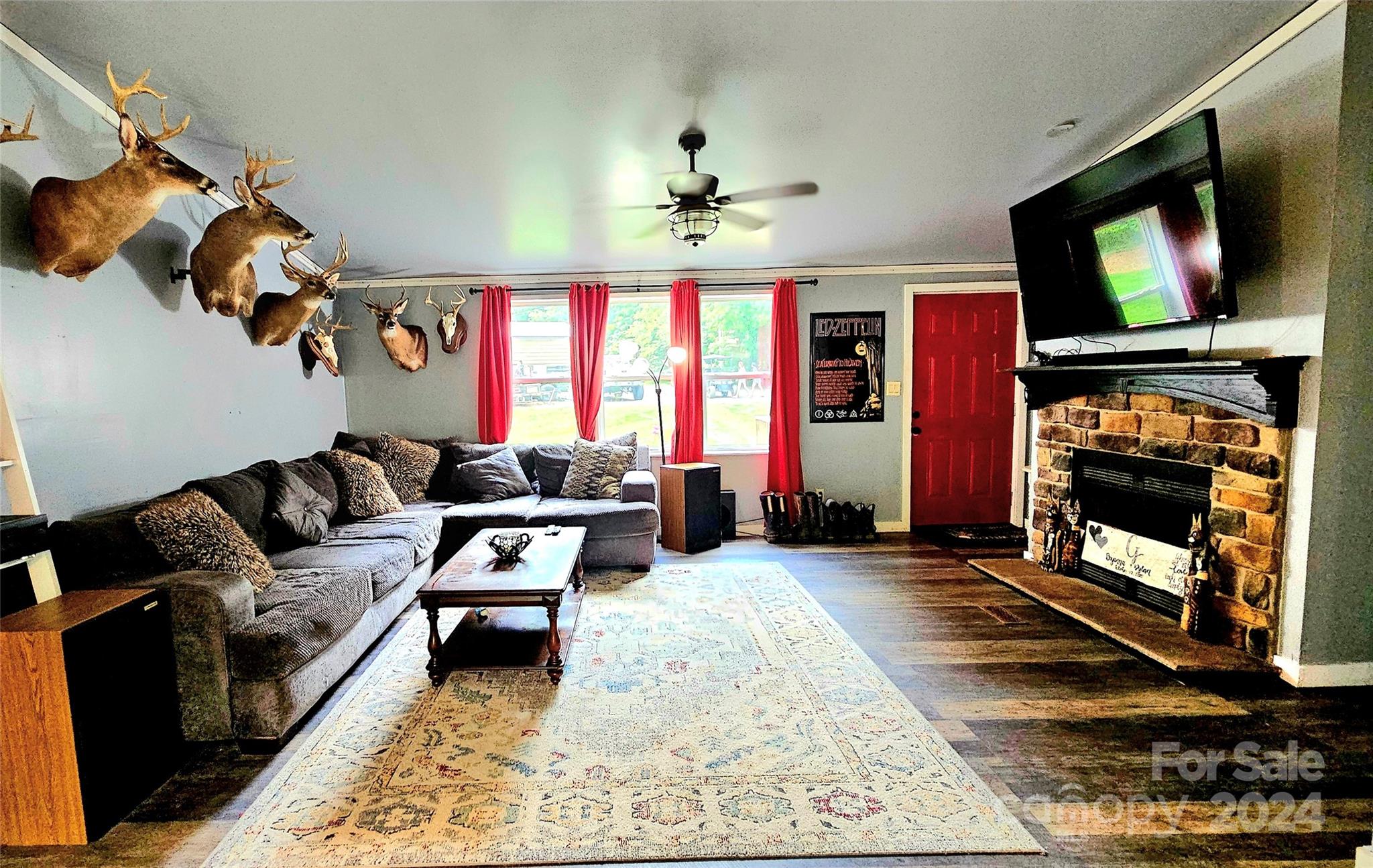 5015 Medlin Road Monroe, NC 28112 - Photo 3 of 19 a living room with furniture a flat screen tv and a fireplace