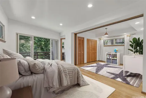 a spacious bedroom with a large bed and a large window