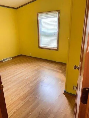 an empty room with a wooden door