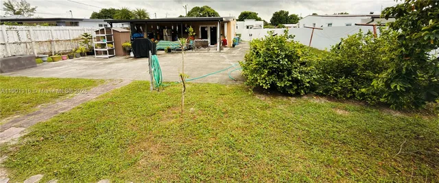 a view of a patio with table and chairs and potted plants