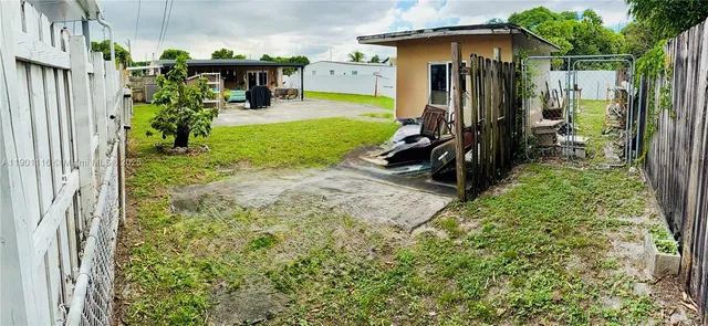 a view of a porch with furniture and a yard