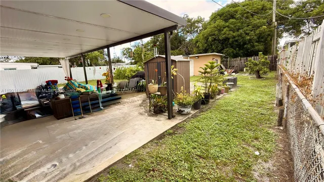 a view of a patio with table and chairs potted plants with wooden floor
