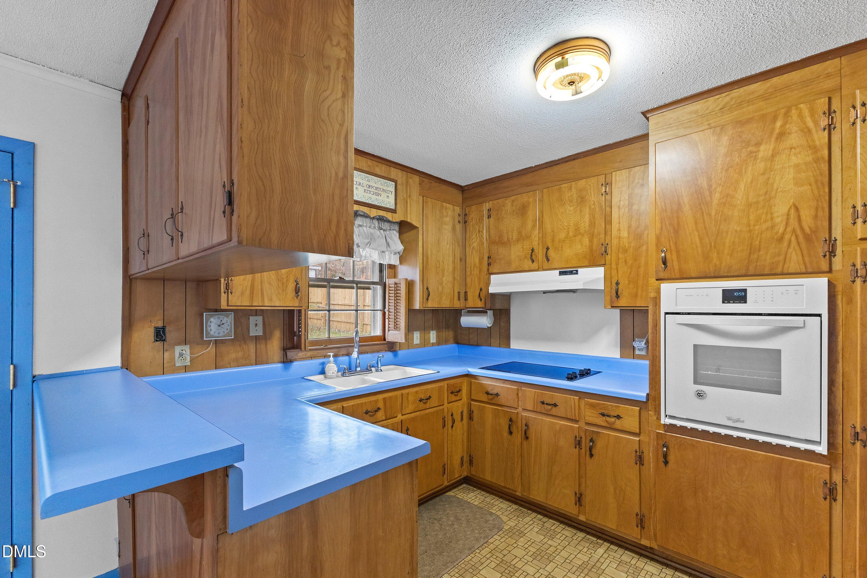 3605 Brentwood Road Raleigh, NC 27604 - Photo 13 of 42 a kitchen with stainless steel appliances granite countertop a sink window and cabinets