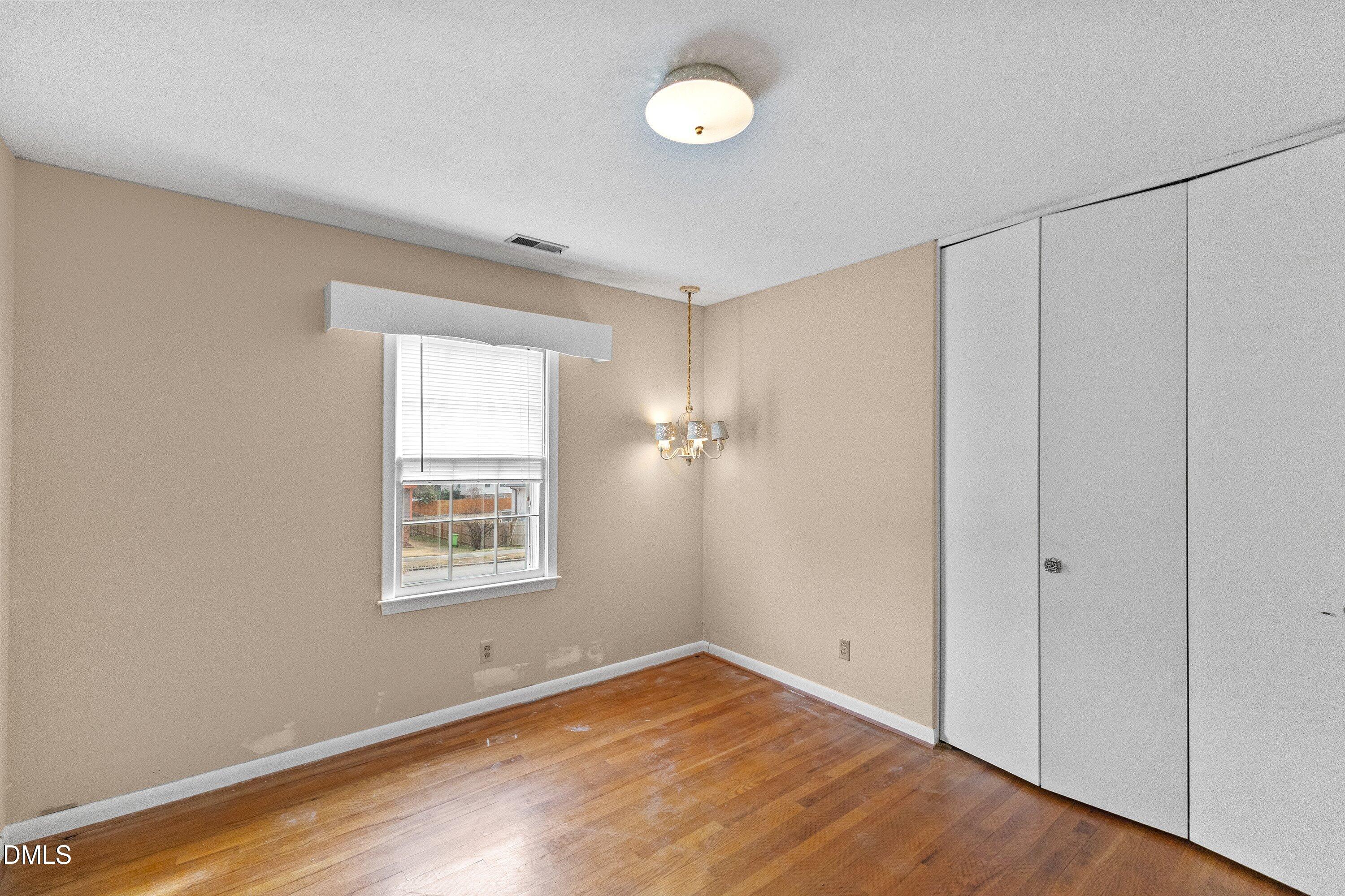 3605 Brentwood Road Raleigh, NC 27604 - Photo 19 of 42 a view of an empty room with wooden floor and a window