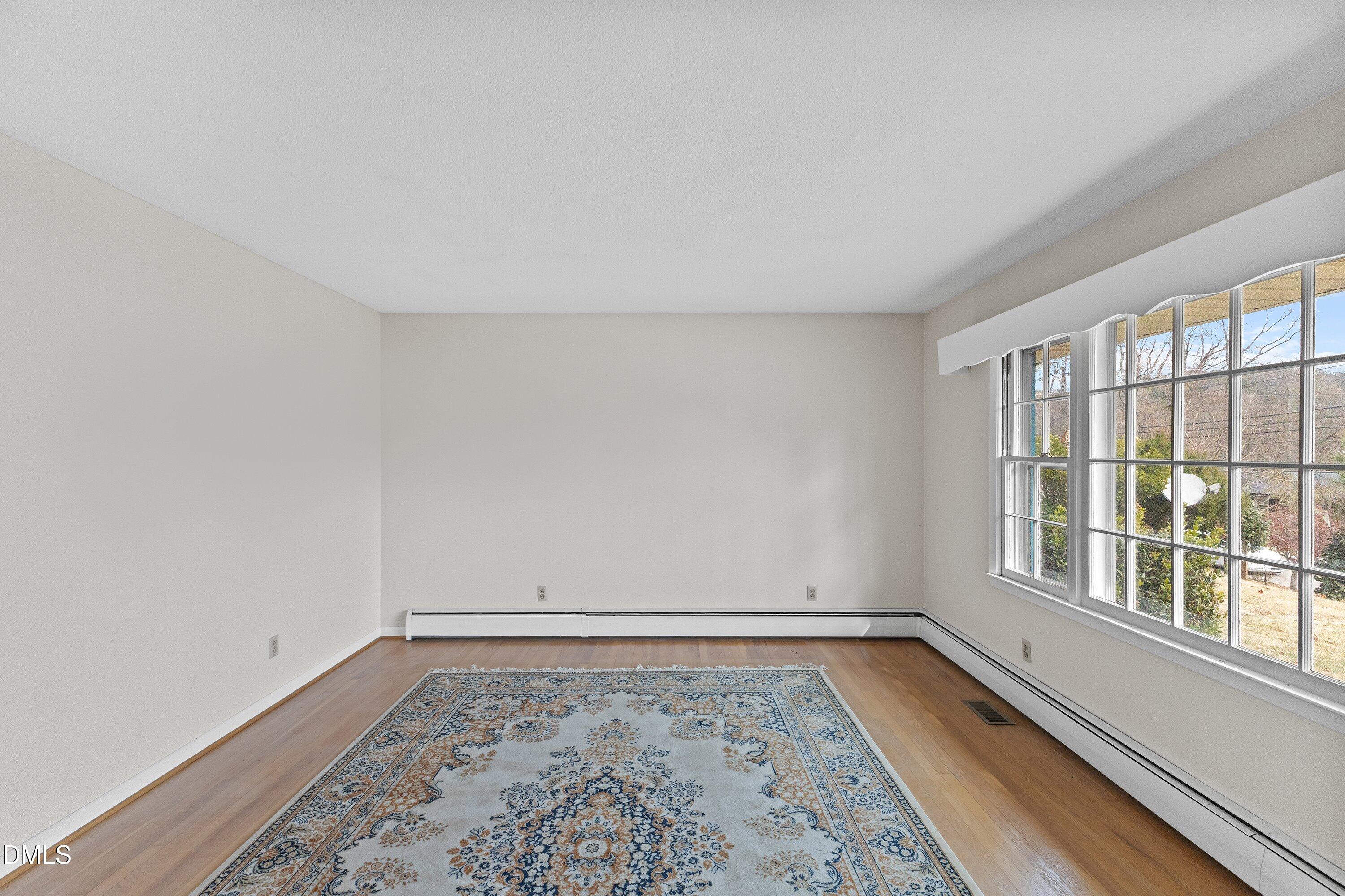 3605 Brentwood Road Raleigh, NC 27604 - Photo 6 of 42 wooden floor in an empty room with a window