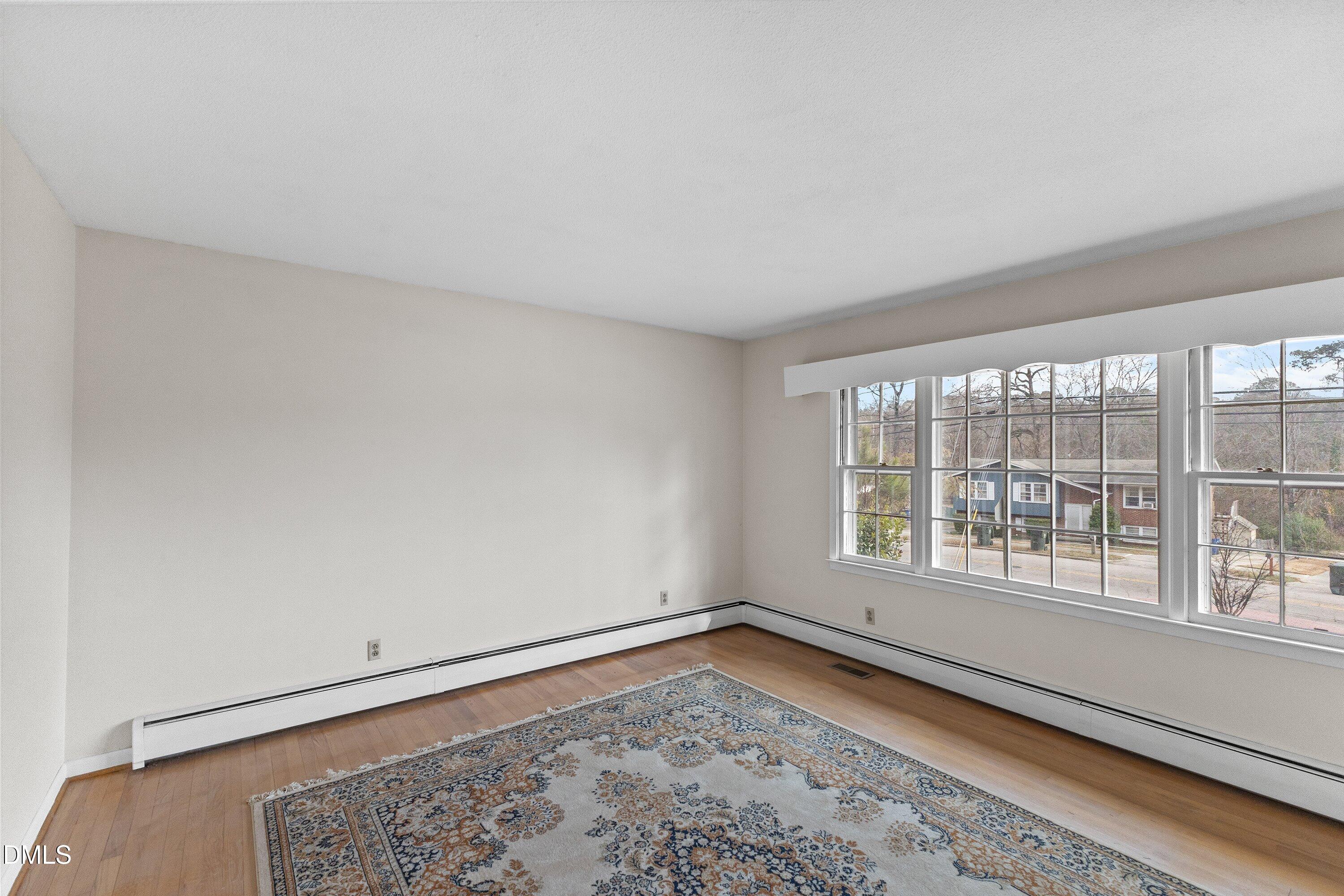 3605 Brentwood Road Raleigh, NC 27604 - Photo 7 of 42 a view of a room with wooden floor and a window