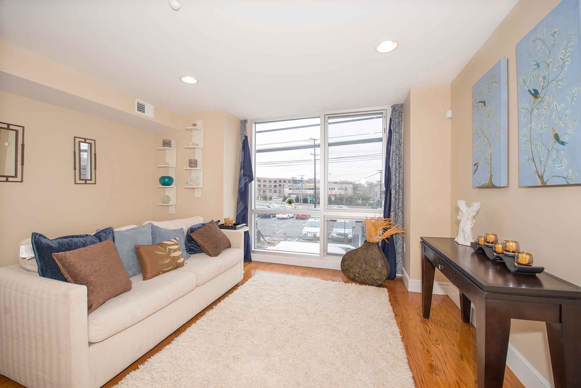 8917 Old River Road, Unit 5 Edgewater, NJ 07047 - Photo 2 of 6 a living room with furniture and a large window