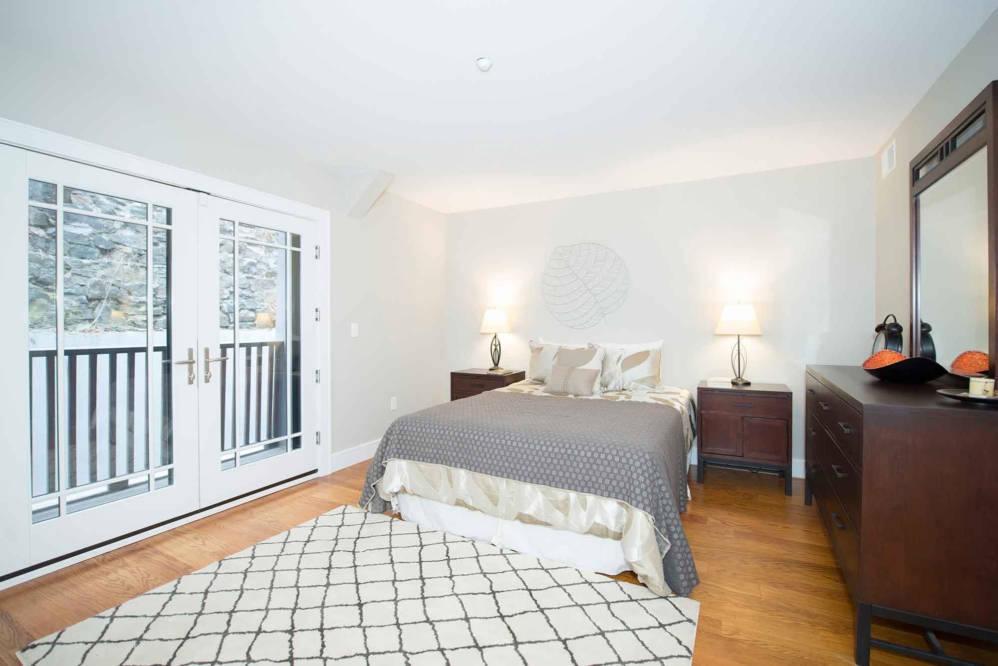 8917 Old River Road, Unit 5 Edgewater, NJ 07047 - Photo 5 of 6 a bedroom with a bed and a window