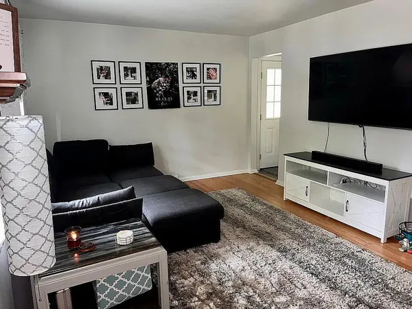 a living room with furniture and a flat screen tv