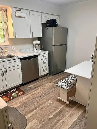 a kitchen with a refrigerator and cabinets