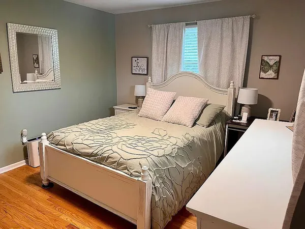 a bed sitting in a bedroom next to a window