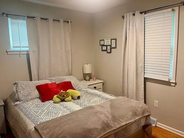 a bedroom with a bed and a window