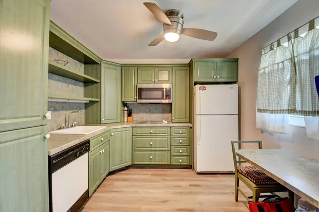 a kitchen with a sink appliances and cabinets