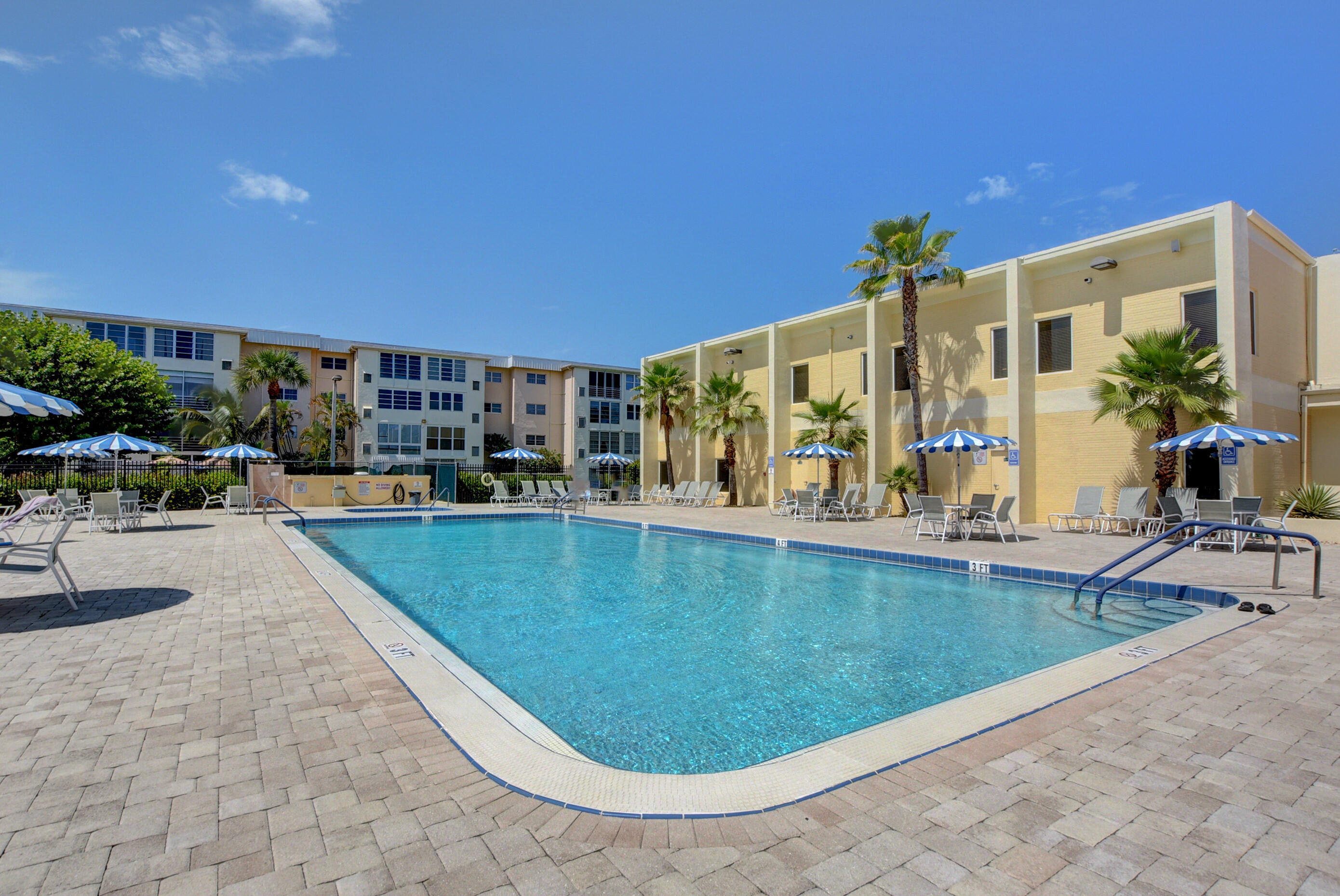 2620 Northeast 1st Court, Unit 403 Boynton Beach, FL 33435 - Photo 26 of 42 a view of swimming pool with outdoor seating
