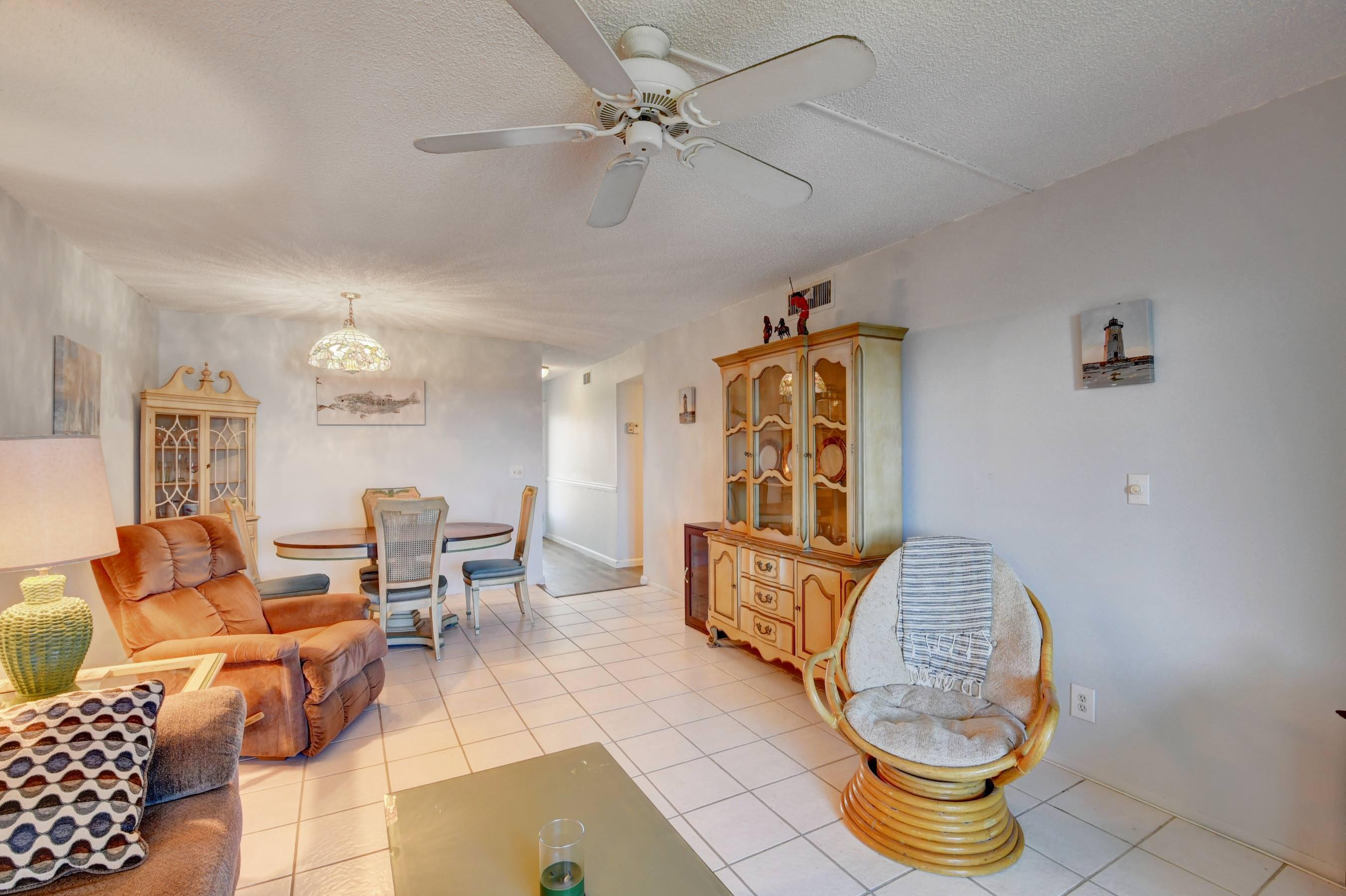 2620 Northeast 1st Court, Unit 403 Boynton Beach, FL 33435 - Photo 10 of 42 a living room with furniture a table and chairs