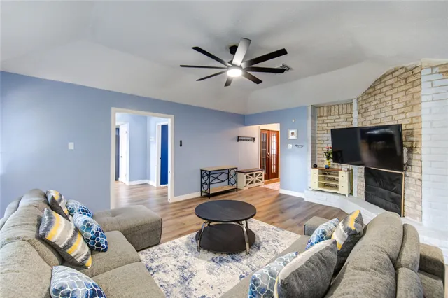 a living room with furniture a flat screen tv and a fireplace