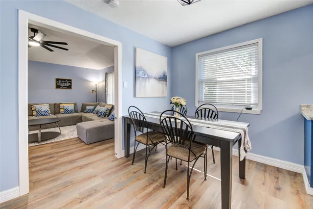 a view of a a dining room with furniture window and wooden floor