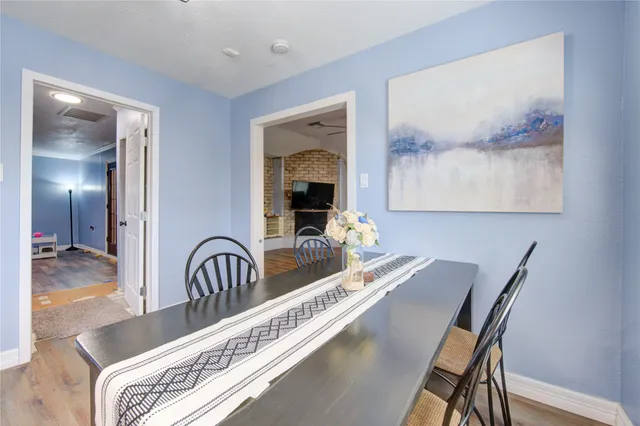 a dining room with furniture and a potted plant