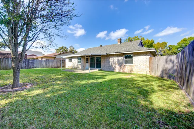 a front view of a house with yard and green space