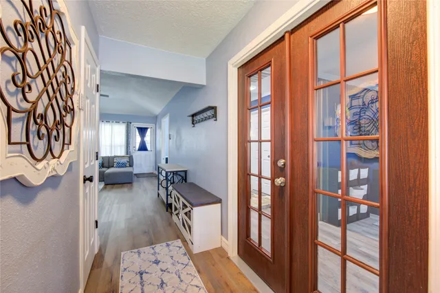 a living room with furniture a window and a wooden floor