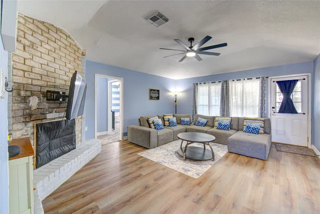 a living room with furniture and a fireplace