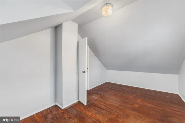 a view of a room with wooden floor and white walls