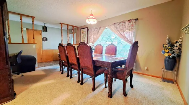 a dining room with furniture and window
