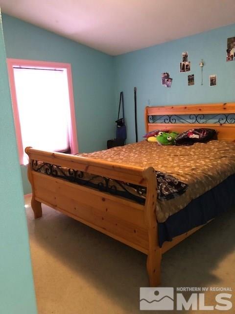 3975 Grouse Way Reno, NV 89508 - Photo 12 of 18 a bed sitting in a bedroom next to a window