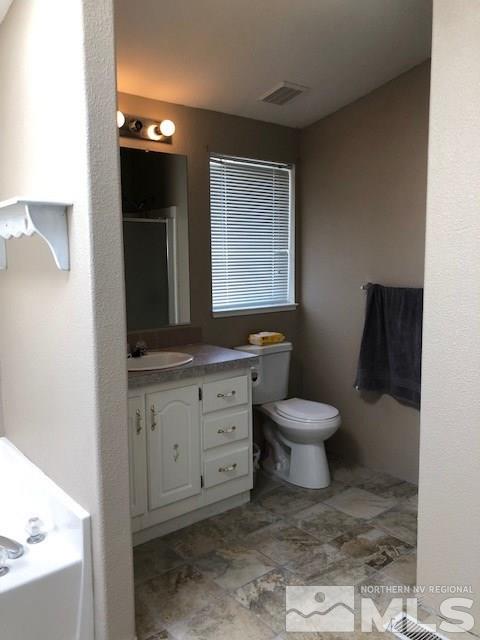3975 Grouse Way Reno, NV 89508 - Photo 15 of 18 a bathroom with a toilet a sink and mirror