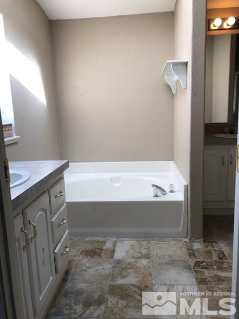 3975 Grouse Way Reno, NV 89508 - Photo 16 of 18 a bathroom with a bathtub and a sink