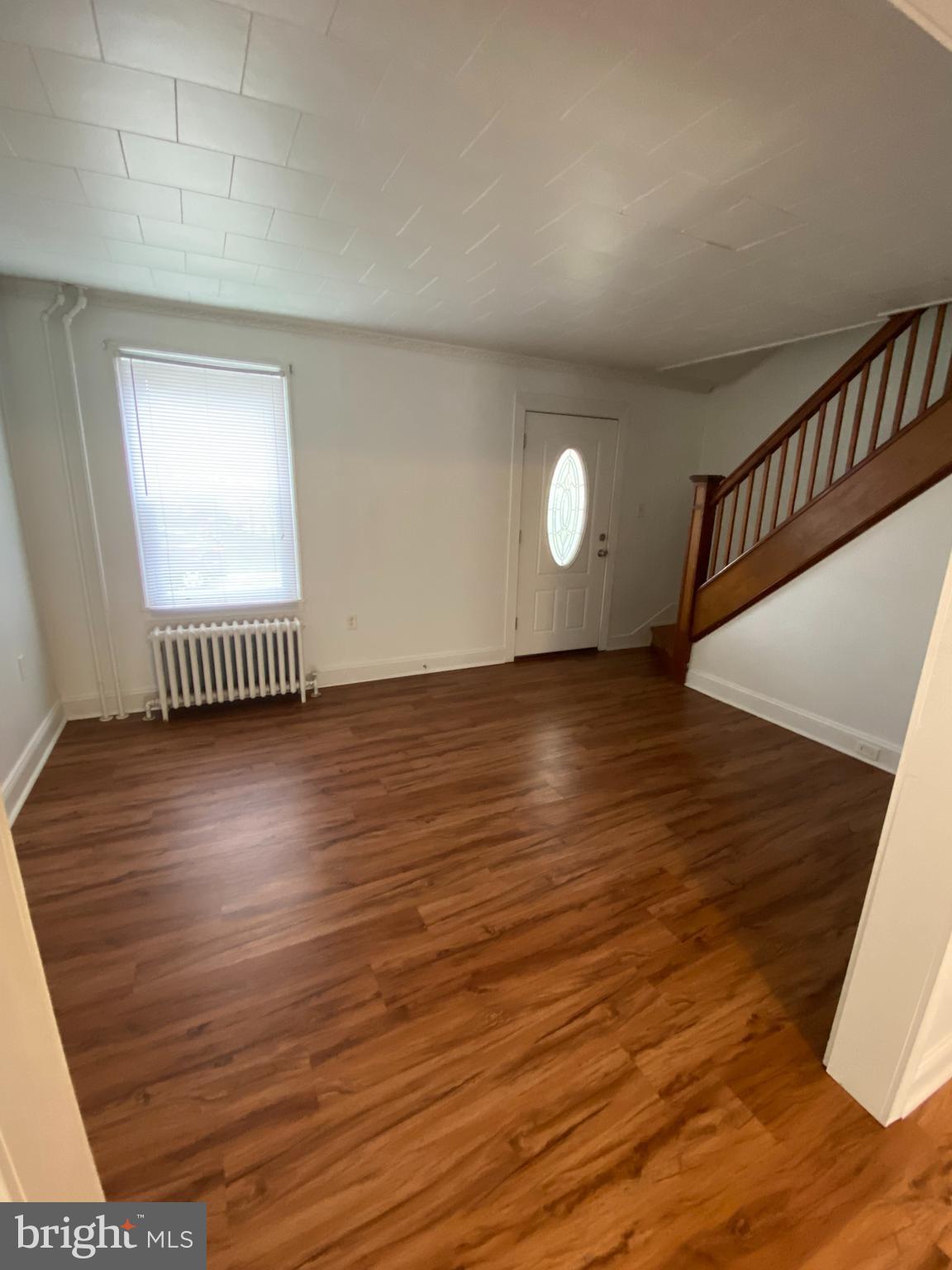 30 Portship Road Baltimore, MD 21222 - Photo 3 of 16 an empty room with wooden floor and windows