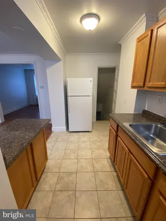 a kitchen with a sink a stove and a refrigerator