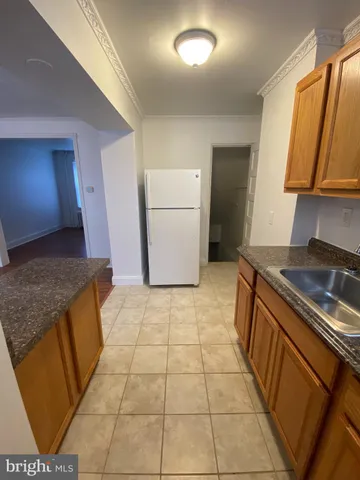a kitchen with a sink a stove and a refrigerator