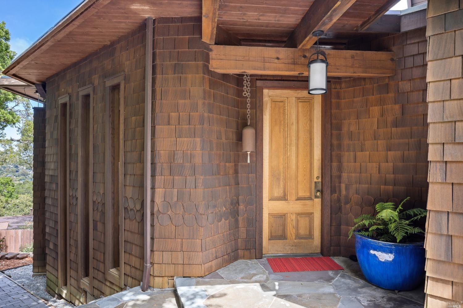 a view of a door and chair front of house