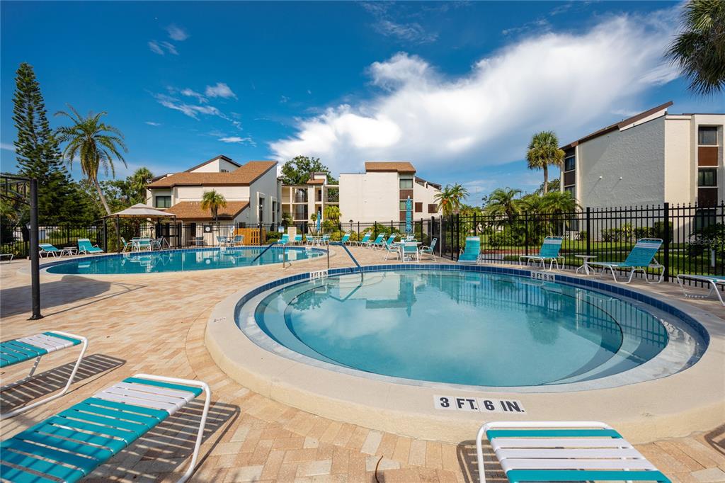 2207 Belleair Road, Unit B4 Clearwater, FL 33764 - Photo 30 of 37 a view of a swimming pool with a patio